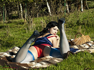 Brunette MILF Wanilianna in blue stockings and red sheer panties flashes her goodies in the open air